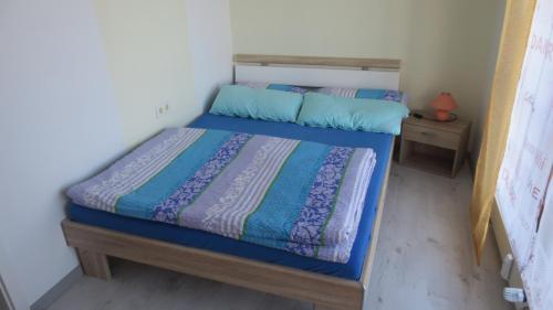 a bedroom with a bed with a blue comforter at Arberblick in Schöfweg