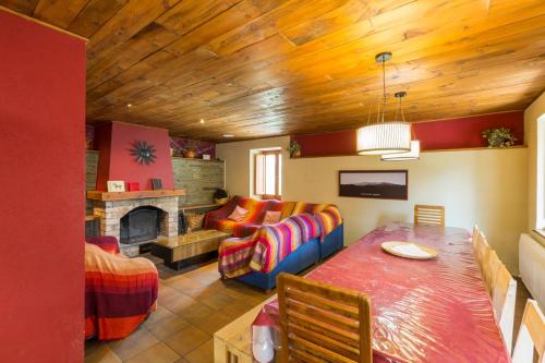 a living room with a table and a couch and a fireplace at Casa Rural al Pirineu in Ansobell