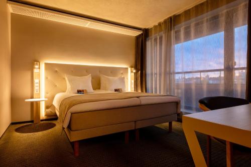 Postel nebo postele na pokoji v ubytování Metropol Spa Hotel