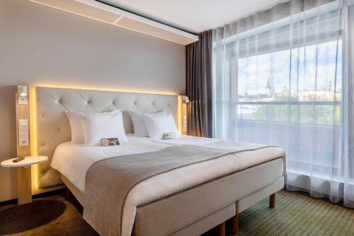 Postel nebo postele na pokoji v ubytování Metropol Spa Hotel