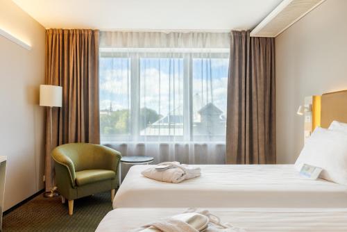 Postel nebo postele na pokoji v ubytování Metropol Spa Hotel