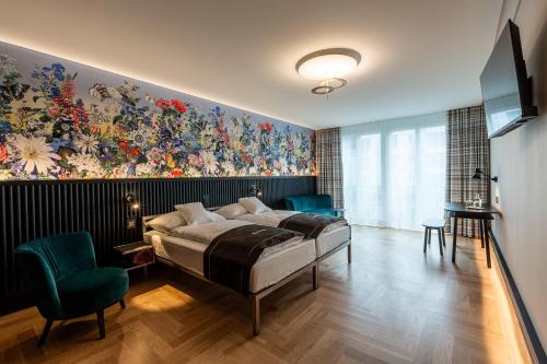 a bedroom with a large painting on the wall at Boutique Hotel Bellevue in Interlaken