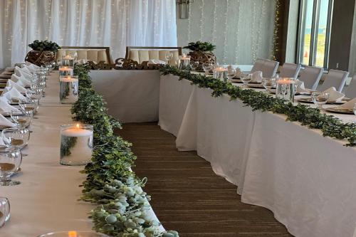 a long table with white tables with flowers and candles at SpringHill Suites by Marriott Navarre Beach in Navarre