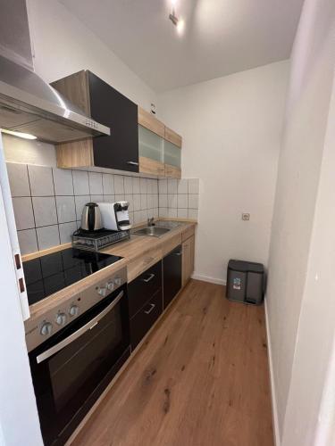 a small kitchen with a stove and a sink at Premium Apartment 1 in Pachten