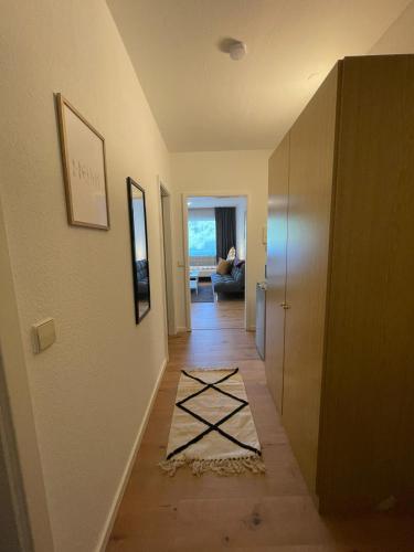 a hallway leading to a living room with a rug on the floor at Premium Apartment 1 in Pachten