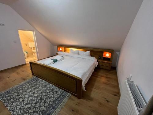 een slaapkamer met een groot bed op zolder bij Cozy Apartment in Gălăuţaş