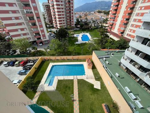 a view of a swimming pool in a city with buildings at Apartamento con encanto y piscina in Fuengirola
