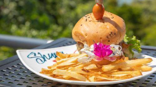 a plate with a sandwich and french fries on a table at Blue Mirador Hotel Manuel Antonio in Manuel Antonio