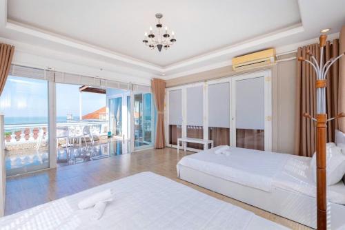a bedroom with two beds and a view of the ocean at Villa BLUE DAY VIEW Biển TRẦN PHÚ Siêu Đẹp in Vung Tau