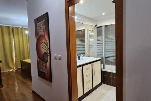 a bathroom with a sink and a mirror at Vista Mar Concórdia by Rentallido in Funchal