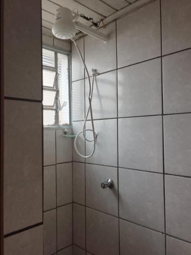 a shower with a shower head in a bathroom at RECANTO DA IZAURINHA in Olímpia