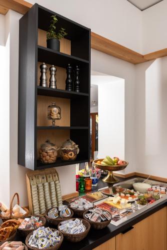 a kitchen with a counter with bowls of food at Hotel Lipa in Kranjska Gora