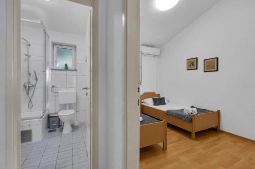 a bathroom with a bed and a bath room at Grande Villa Horizon in Makarska
