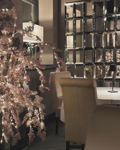 a living room with a christmas tree and chairs at The Q Hotel in Shanklin