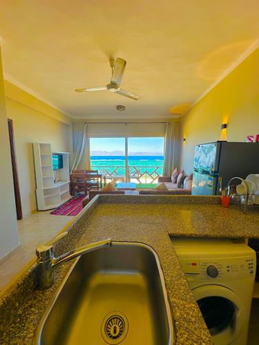 a kitchen with a sink and a view of the ocean at Moon house n.30 in Dahab