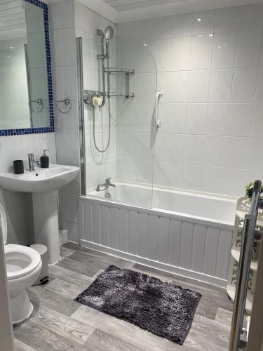 a bathroom with a tub and a toilet and a sink at Luxury 2 Bedroom Aparmant in Morley in Morley