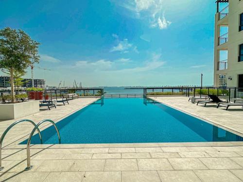 a swimming pool in a building with a view of the ocean at HiGuests - Family Dream Escape with Private Beach Access in Dubai