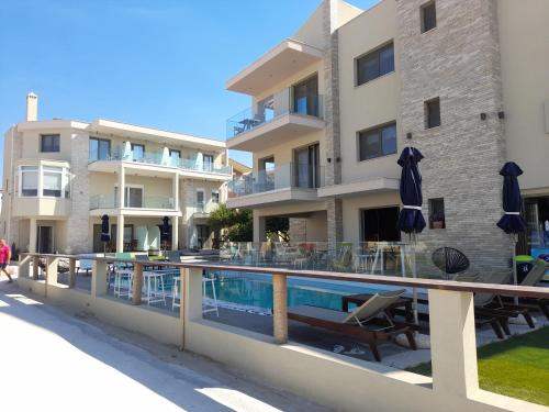 a swimming pool in front of a building at Reverie in Limenaria
