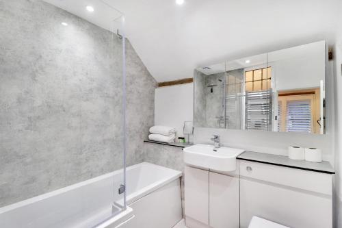 a white bathroom with a sink and a shower at Perfectly Presented Cottage Pass the Keys in Robertsbridge
