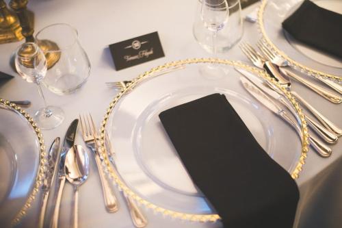 a table with a plate with a cell phone on it at Hotel Focus Centrum Konferencyjne in Lublin