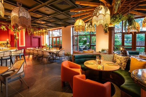 a restaurant with tables and chairs and chandeliers at Hilton Mauritius Resort & Spa in Flic-en-Flac