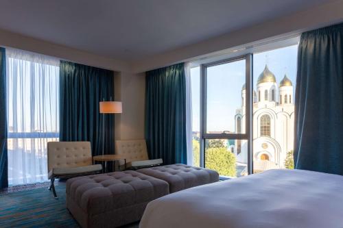 a hotel room with a bed and a large window at Radisson Blu Hotel Kaliningrad in Kaliningrad