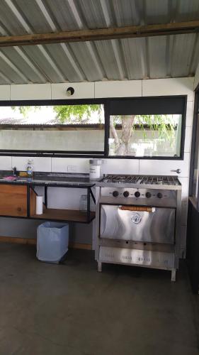 a kitchen with a stove and a window in it at La Quinta de LOS ABU in Ramallo