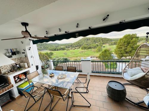 a living room with a table and chairs on a balcony at FLAT Surrounded by Nature WIFI & Pool & beach Nearby in Son Parc