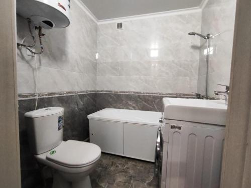 a small bathroom with a toilet and a sink at Квартира посуточно in Kokshetau