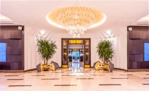 a lobby of a hotel with a chandelier at Hilton Samarkand Regency in Samarkand