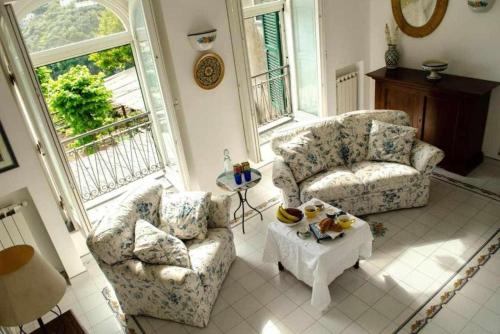 sala de estar con 2 sillas y mesa en Villa Piccinina A pochi passi da Villa Eva en Ravello