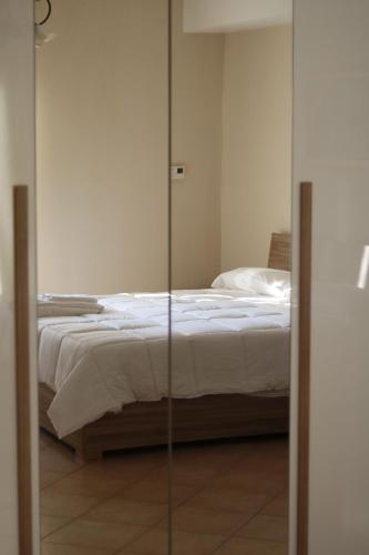 a bedroom with a bed and a glass door at CASA HYRIA in Nola