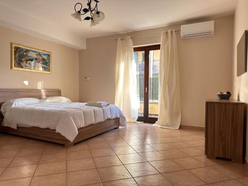 a bedroom with a bed and a large window at CASA HYRIA in Nola