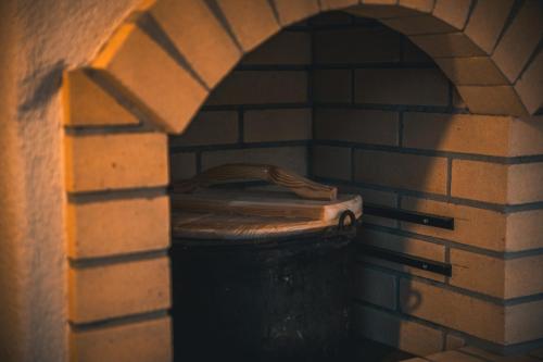 a brick room with a trash can in a brick wall at Villa Seraf in Terchová