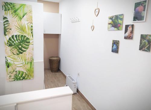 a room with a white wall with paintings on it at Apartamento Loft La Magdalena in Córdoba