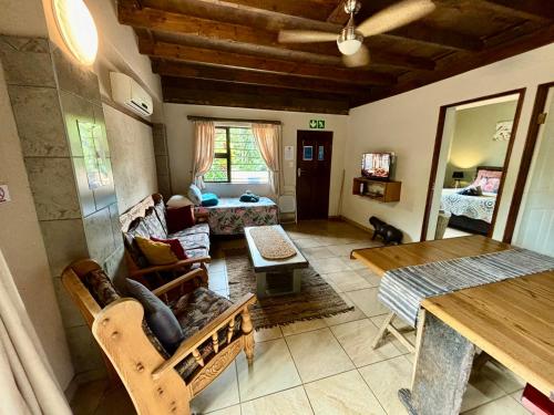 a living room with a couch and a table at Boomhuisie in Komatipoort