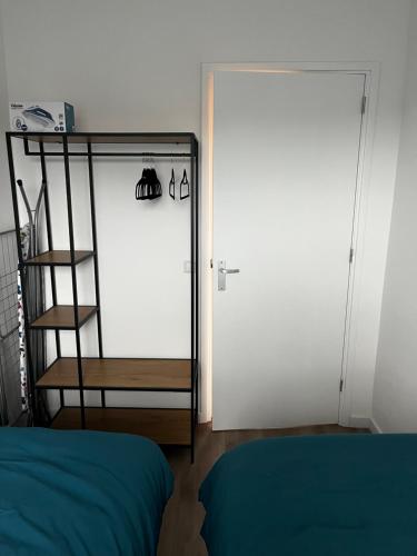 una camera con una porta bianca e un letto blu di Da Costa 12B a Leida