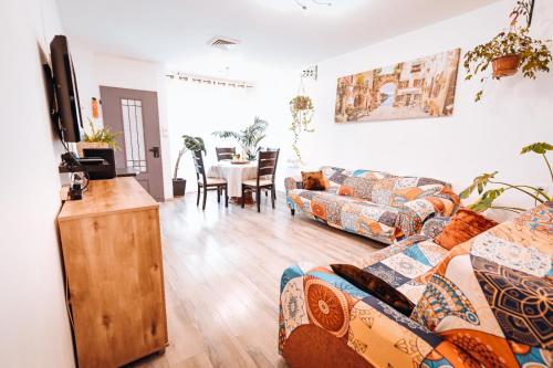 a living room with two couches and a table at Limor-resident in Qasrîne