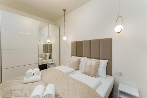 a bedroom with two beds with white shoes on them at Apartament Marmurowy Ku Morzu by Holidaysun in Sianozety
