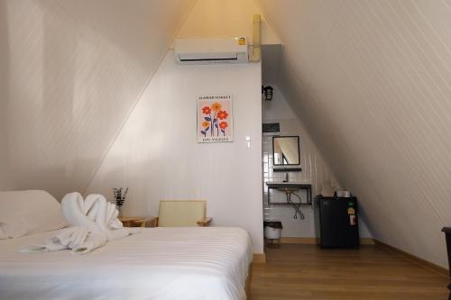 a bedroom with a white bed and a staircase at It my life cafe x camp in Ban Tha Sai