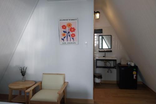 a stairway with a chair and a picture on the wall at It my life cafe x camp in Ban Tha Sai