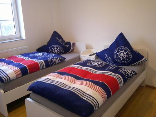 two beds with pillows on them in a room at Unseburg-Ferienwohnung 3 