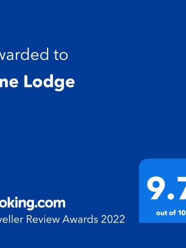 a blue sign with the text translated to crime lodge at Pine Lodge in Gorebridge