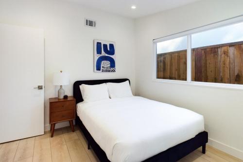 a bedroom with a white bed and a window at Cupertino 3br w patio backyard nr restaurants SFO-1636 in Cupertino