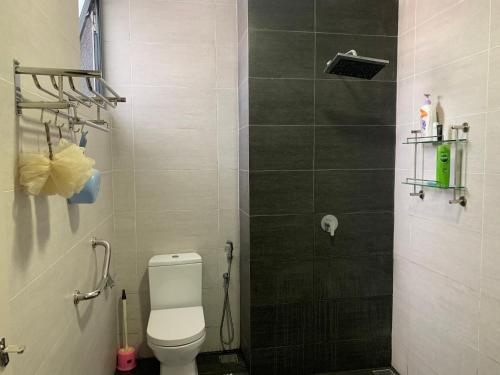 a small bathroom with a toilet and a shower at Lovely 2-BR service apartment with pool (melur @ troikaKB) in Kota Bharu