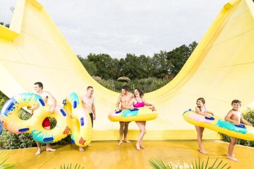 a group of people sitting on inflatables at a water park at Parfum dEmbruns in Hirel