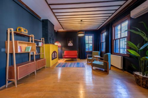 a living room with blue walls and a red chair at The Kosk -5Br Villa with Turkish Bath- City Centre in Istanbul