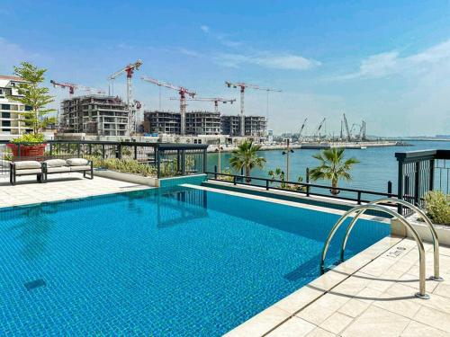 a swimming pool on a building with a view of the water at HiGuests - Dream Vacation Apartment in La Rive 1 in Dubai