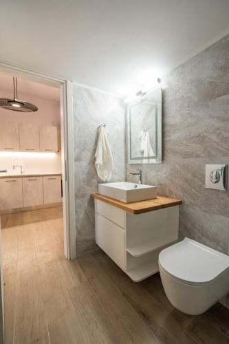 a bathroom with a white sink and a toilet at Luxury Serenity in Piraeus