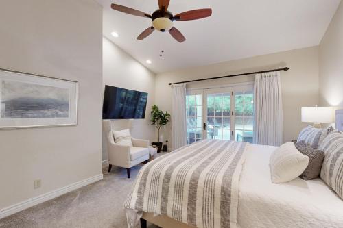 a bedroom with a bed and a ceiling fan at Sun-Kissed in Scottsdale in Phoenix